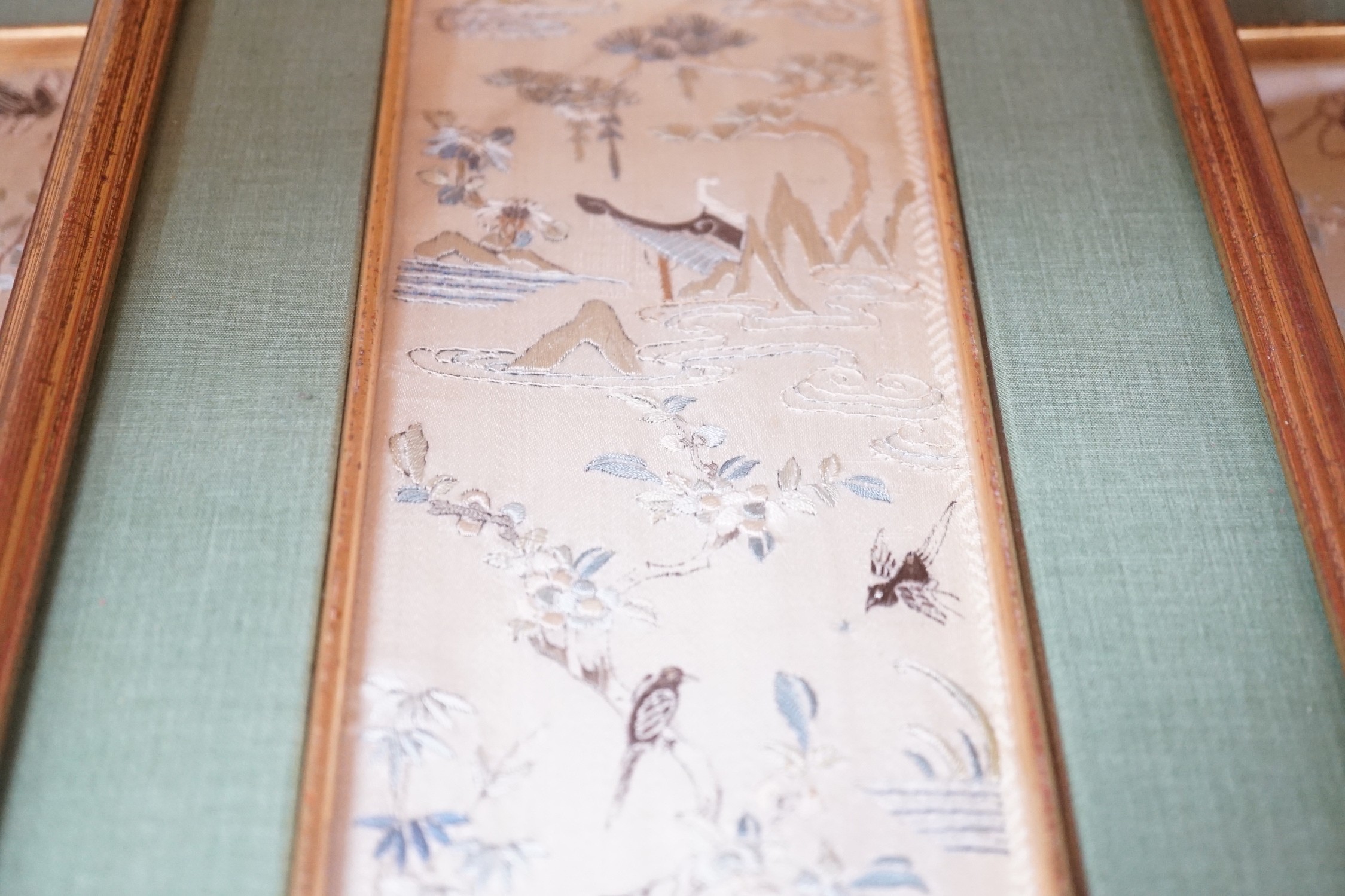 Three pairs of gilt framed, 19th century, silk embroidered, sleeve bands (for Chinese robes), 49cms long x 9cms wide (not including mount or frame)